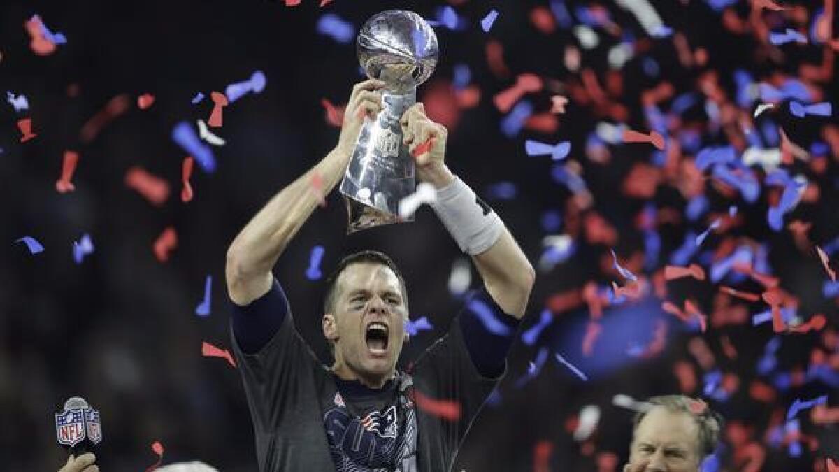 Patriots quarterback Tom Brady hoists the Vince Lombardi Trophy after Super Bowl LI.