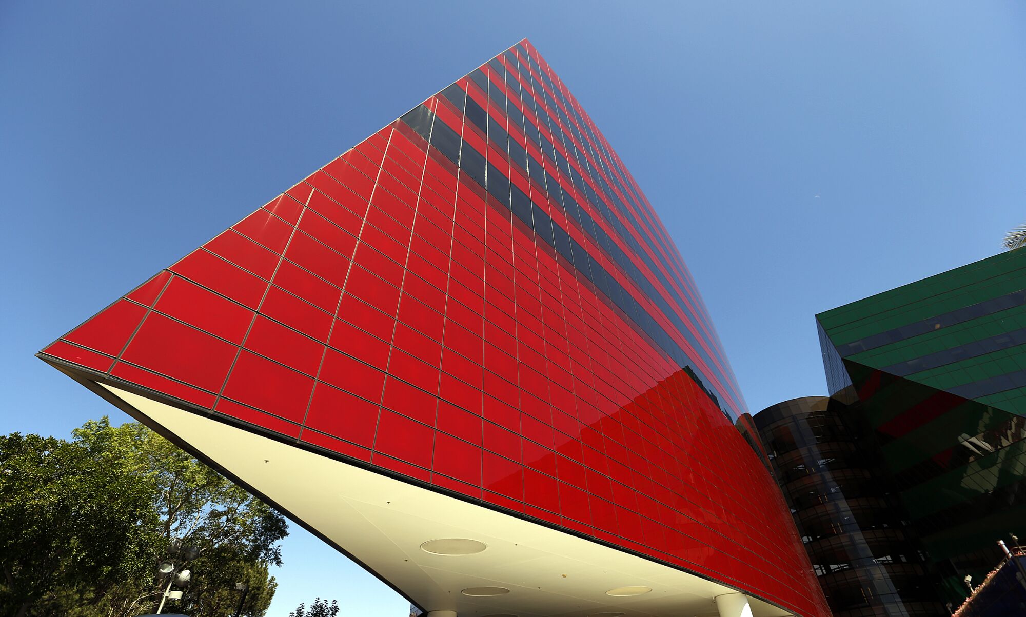 A photo shows a triangle-shaped part of a building that is red with black horizontal stripes.