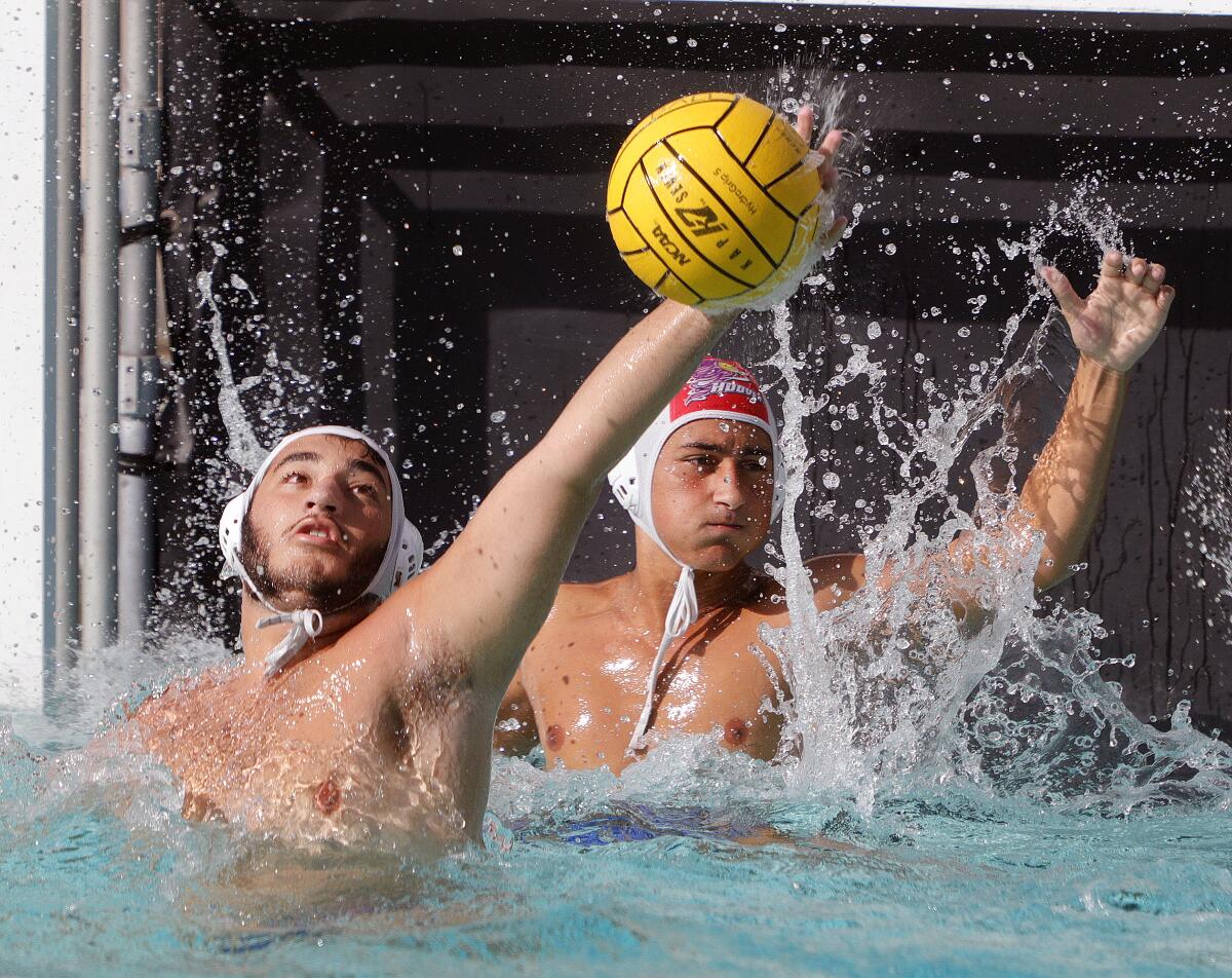 Burbank's Grigor Gasabian blocks a Hoover pass in a Pacific League boys' water polo match at Hoover High School on Thursday, October 10, 2019. Hoover won the match.