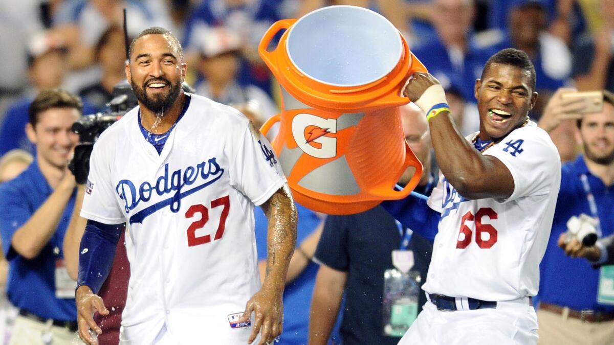 Yasiel Puig, right, doused Matt Kemp (27) with water after the Dodgers defeated the St. Louis Cardinals in Game 2 of the 2014 National League divisional series.