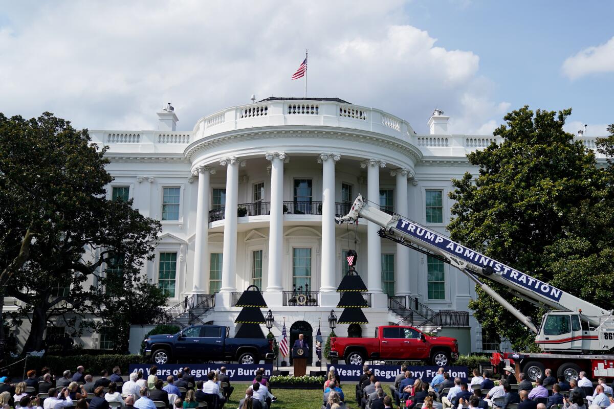 President Trump speaks on the South Lawn of the White House on July 16 with trucks and props in the background.