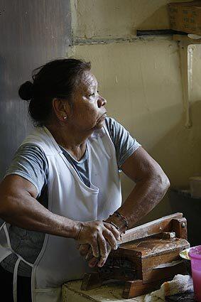 Maria Hernandez has been making corn tortillas on a wooden tortilla press for the last 10 years at Playa Azul market in Florence-Firestone, an unincorporated neighborhood in L.A. County. Playa Azul is a family-owned business whose operators fear that a Wal-Mart could erode the small-business climate.