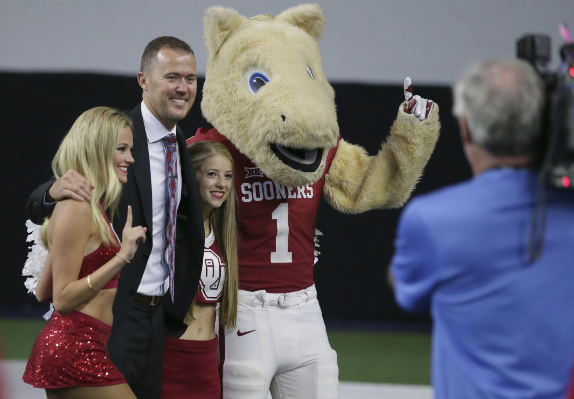 Oklahoma coach Lincoln Riley poses for photos during the Big 12 college football media day in 2017.