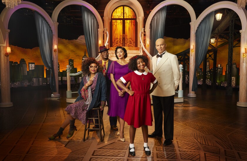 This image released by NBC shows the cast of "Annie Live!," from left, Taraji P. Henson as Miss Hannigan, Tituss Burgess as Rooster Hannigan, Nicole Scherzinger as Grace Farrell, Celina Smith as Annie, and Harry Connick, Jr. as Daddy Warbucks. The tale of the spunky young orphan with her dog Sandy set during the Depression airs Dec. 2 on NBC. (Paul Gilmore/NBC via AP)