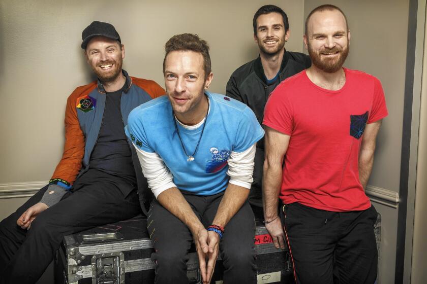 Coldplay: Jonny Buckland, left, Chris Martin, Guy Berryman and Will Champion at CBS studios before a taping of the "The Late Show with James Corden" on Nov. 12, 2015.