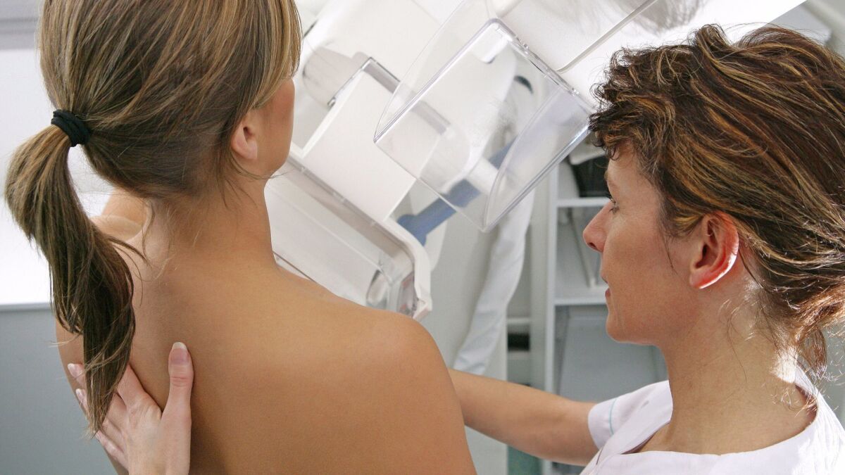 A medical workers administers a mammogram at Rouen University Hospital in France.