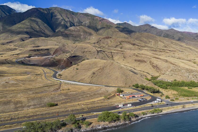 Olowalu temporary landfill site for the debris from the Lahaina fire is seen on Sunday, July 7, 2024, in Lahaina, Hawaii. (AP Photo/Mengshin Lin)