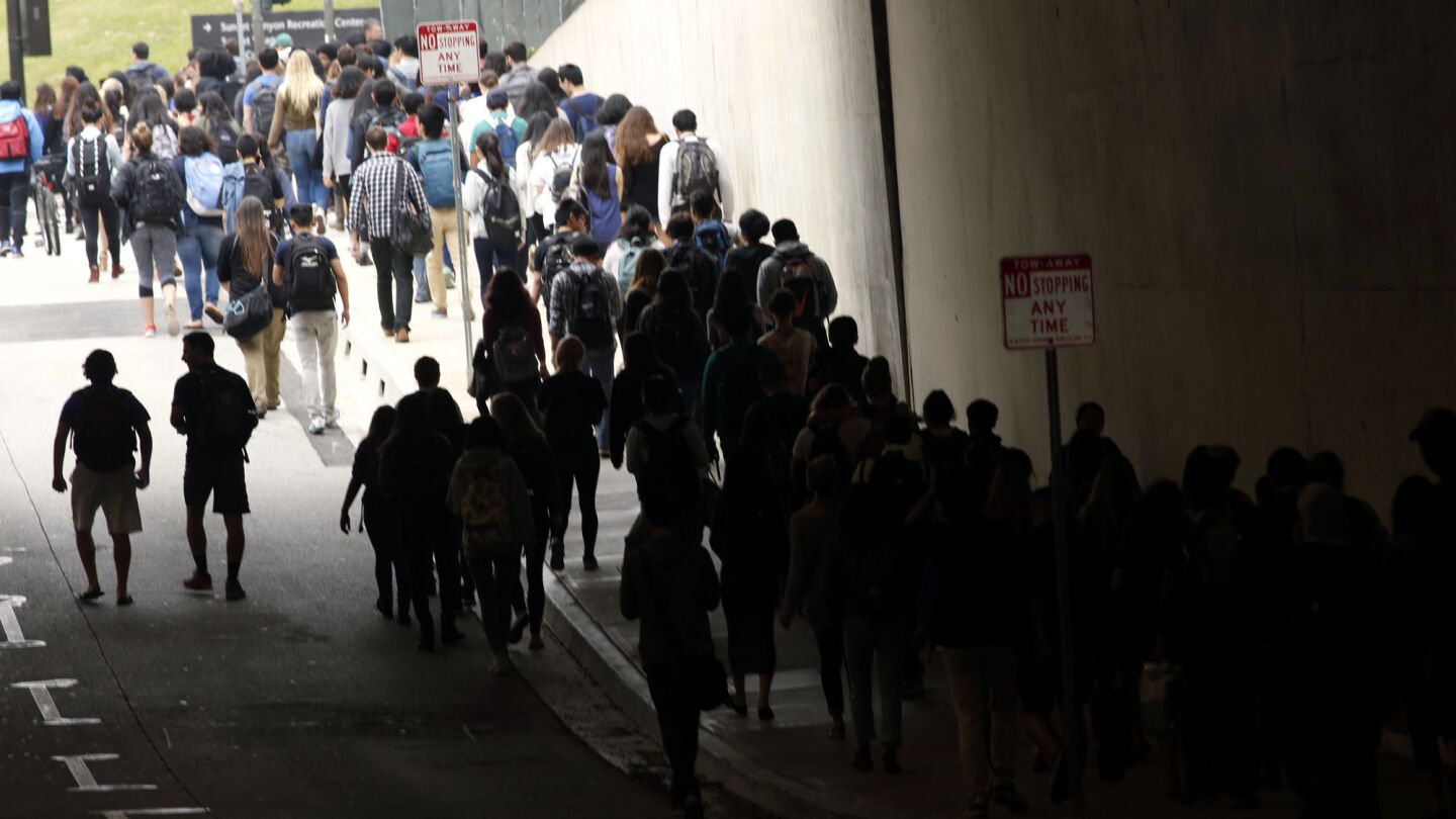 Hundreds of UCLA students leave the UCLA campus after the lockdown was called off after two people were shot on campus.