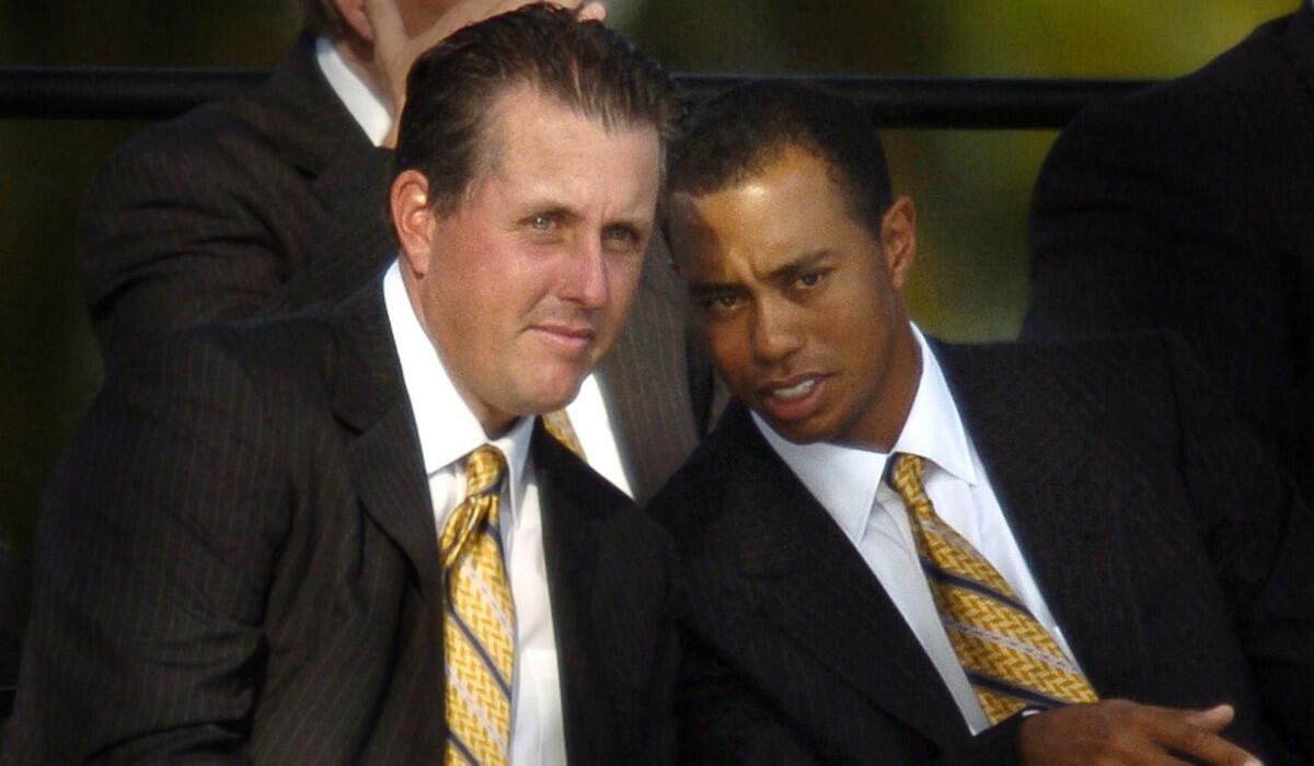 Phil Mickelson, left, and Tiger Woods talk during opening ceremonies for the 2004 Ryder Cup.