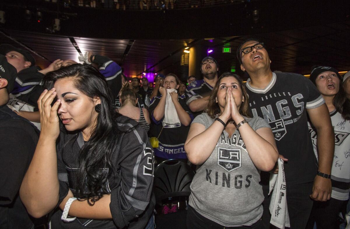 Kings fans react at Club Nokia at L.A. Live on Wednesday night as they watch Game 4 of the Stanley Cup Finals.