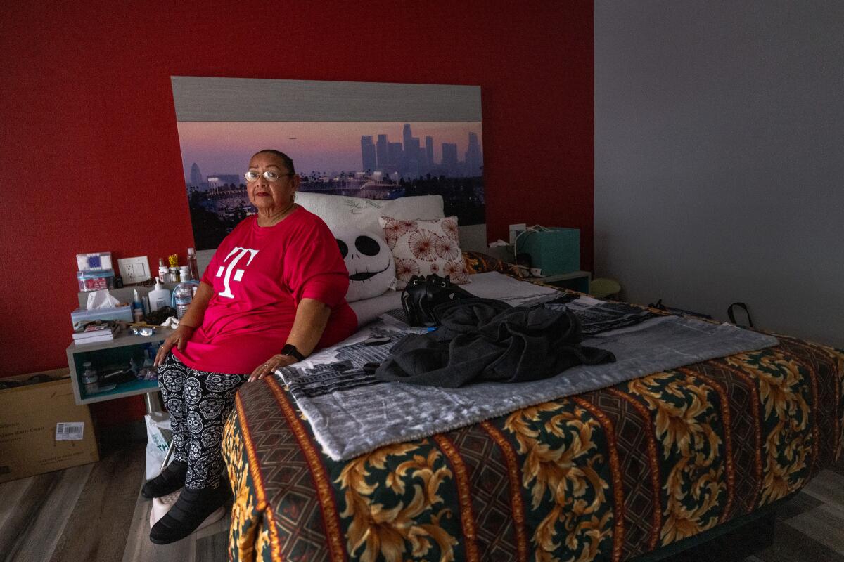 Maria Briones inside her motel room as she waits to find housing in Los Angeles.