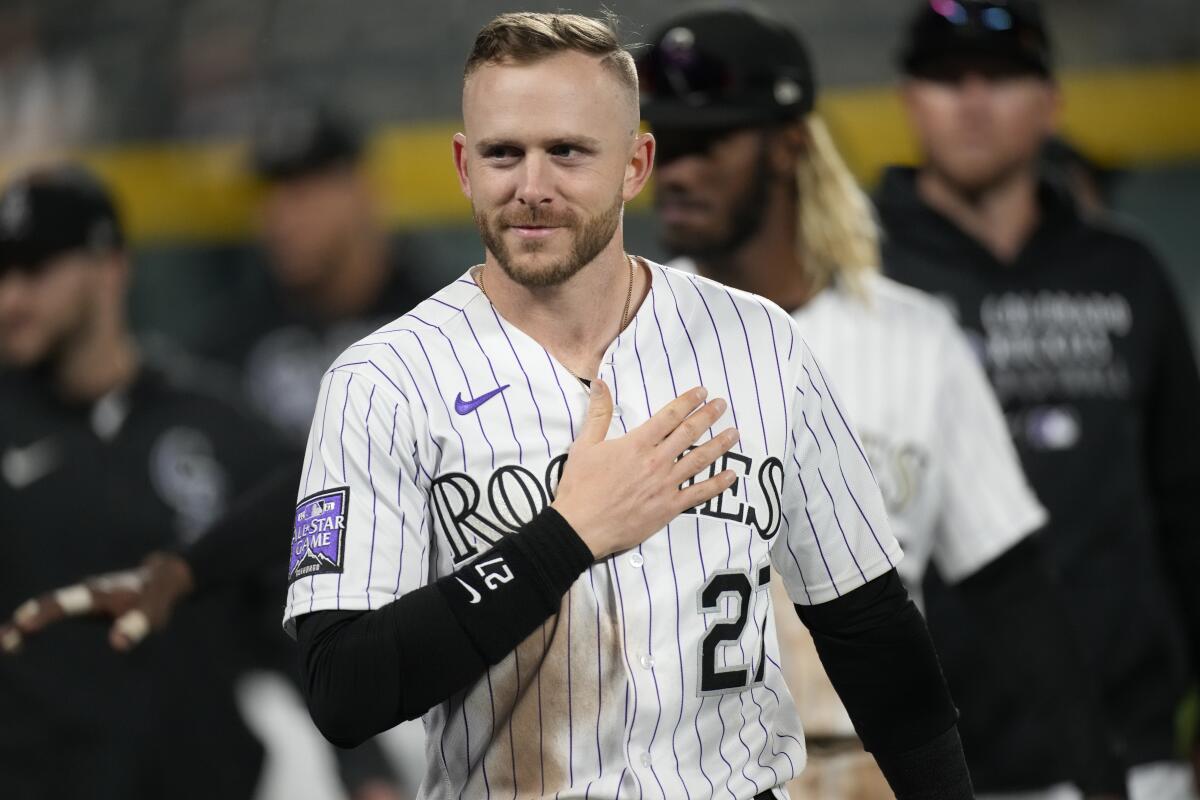 Colorado Rockies shortstop Trevor Story gestures to the crowd during a ceremonial walk around the park after a baseball game Wednesday, Sept. 29, 2021, in Denver. The Rockies posted a 10-5 victory over the Washington Nationals. Story is set to be a free agent in thee off-season. (AP Photo/David Zalubowski)