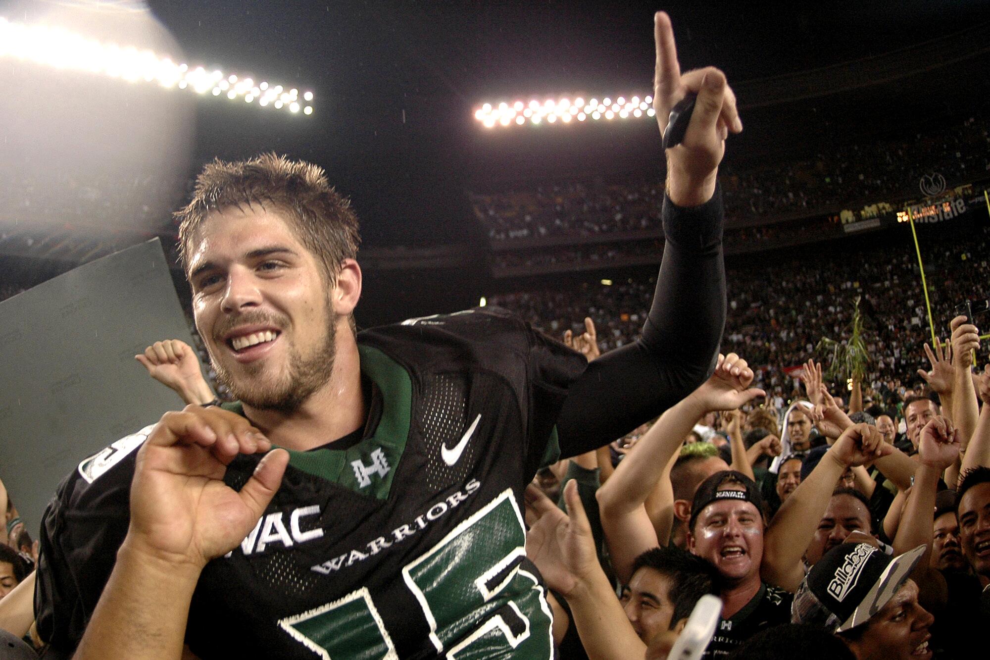 Colt Brennan celebrates after leading Hawaii to victory over Boise State on Nov. 23, 2007.