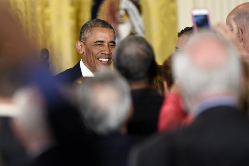 President Obama greets guests Monday at a White House conference on aging.