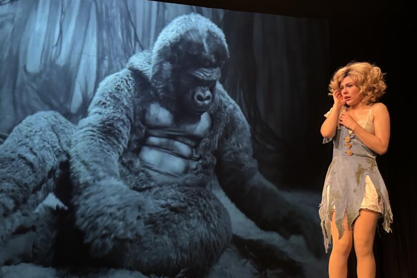 King Kong is performed live backstage so that he can appear larger-than-life on the screen behind Ann Darrow.