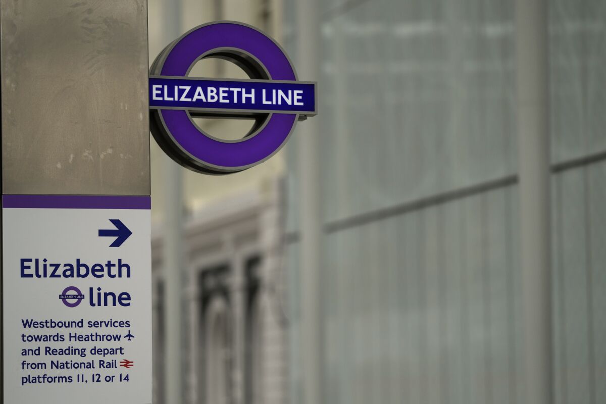 Signs for the new Elizabeth Line entrance at Paddington for the new rail route through central London from the commuter towns of Reading in the west and Shenfield in the East, during a media visit in London Wednesday, May 11, 2022. (AP Photo/Alastair Grant)
