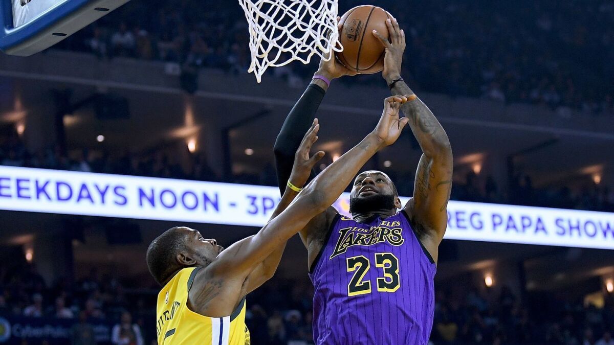 Lakers forward LeBron James, drawing a foul from Warriors forward Kevin Durant on Christmas, is putting up MVP numbers again this season.
