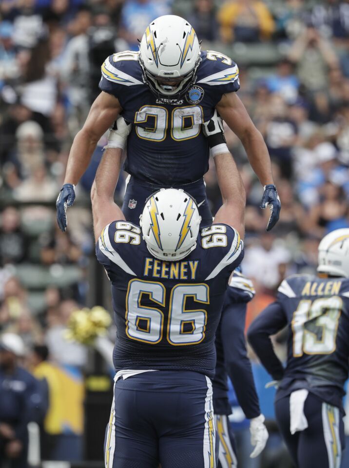 Chargers running back Austin Ekeler is lifted by offensive lineman Dan Feeney after Ekeler scored during the second quarter.