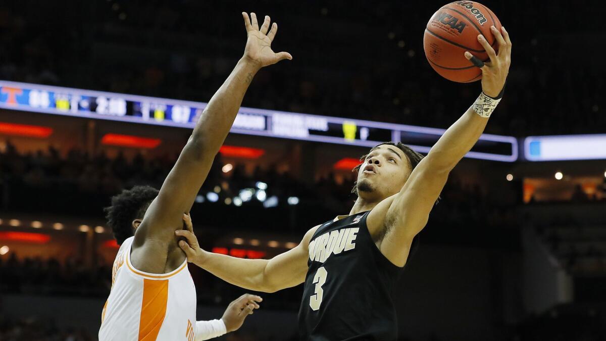 Purdue's Carsen Edwards, right, goes up for a layup against Tennessee's Admiral Schofield during overtime of the NCAA tournament South Regional on Thursday in Louisville, Ky.