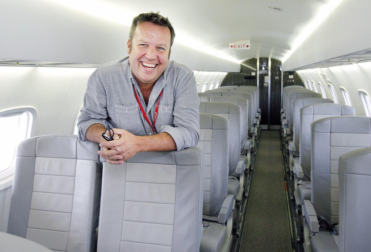 JetSuite publicist Gareth Edmondson-Jones stands inside the cabin of an Embraer 135 aircraft. Irvine-based JetSuite is launching its newest service, JetSuiteX, which will connect Burbank to Concord in the East Bay.