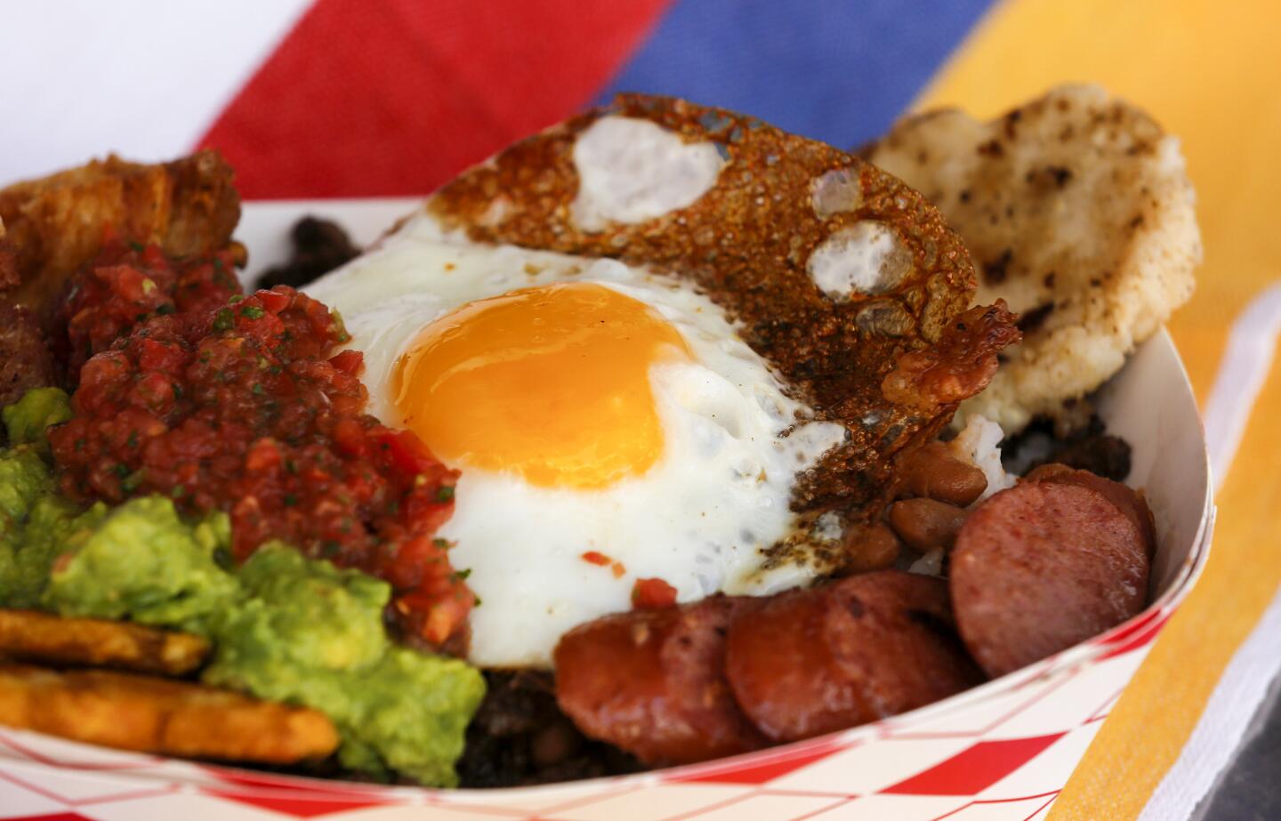 The Paisa Bowl is a protein-packed serving of pork belly, steak, sausage, beans, white rice, plantains, avocado and an arepa topped with a fried egg, from the Cali Fresh food truck.