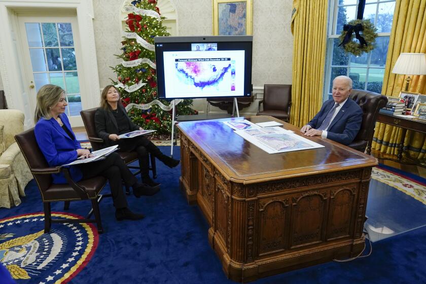 President Joe Biden participates in a briefing on winter storms across the United States in the Oval Office of the White House, Thursday, Dec. 22, 2022, in Washington. Liz Sherwood-Randall, assistant to the President, Homeland Security Advisor & Deputy National Security Advisor, left, and Julie Chavez Rodriguez, senior advisor to the President and Director of the Office of Intergovernmental Affairs, second from left. (AP Photo/Patrick Semansky)