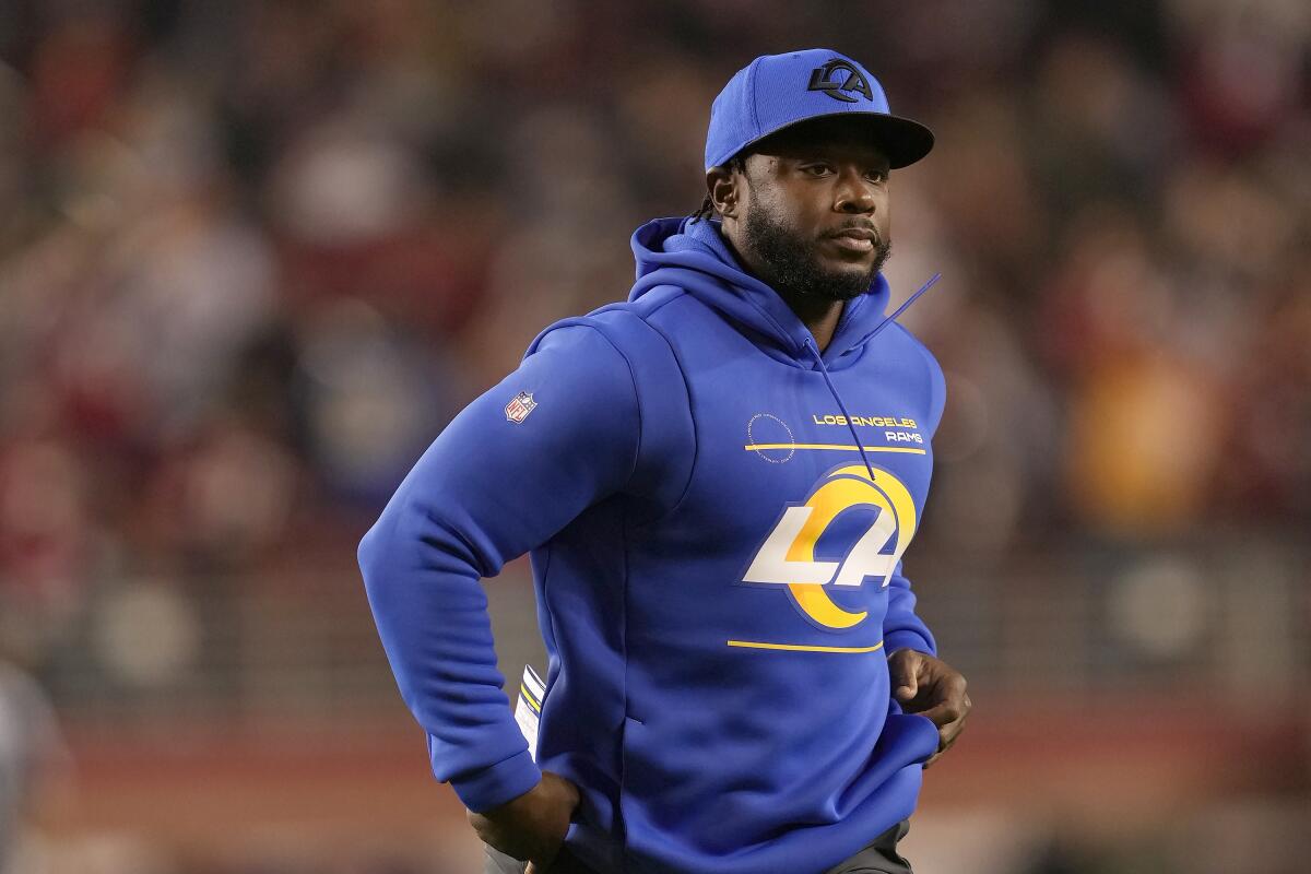 Thomas Brown in a Los Angeles Rams sweatshirt stands during an NFL game