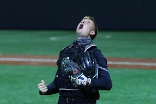 Catcher Trent Grindlinger of Huntington Beach shows off emotion after tagging out Mater Dei runner in extra innings.