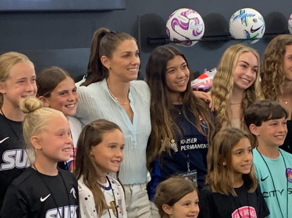 San Diego Wave star Alex Morgan poses with kids at Wednesday's event.