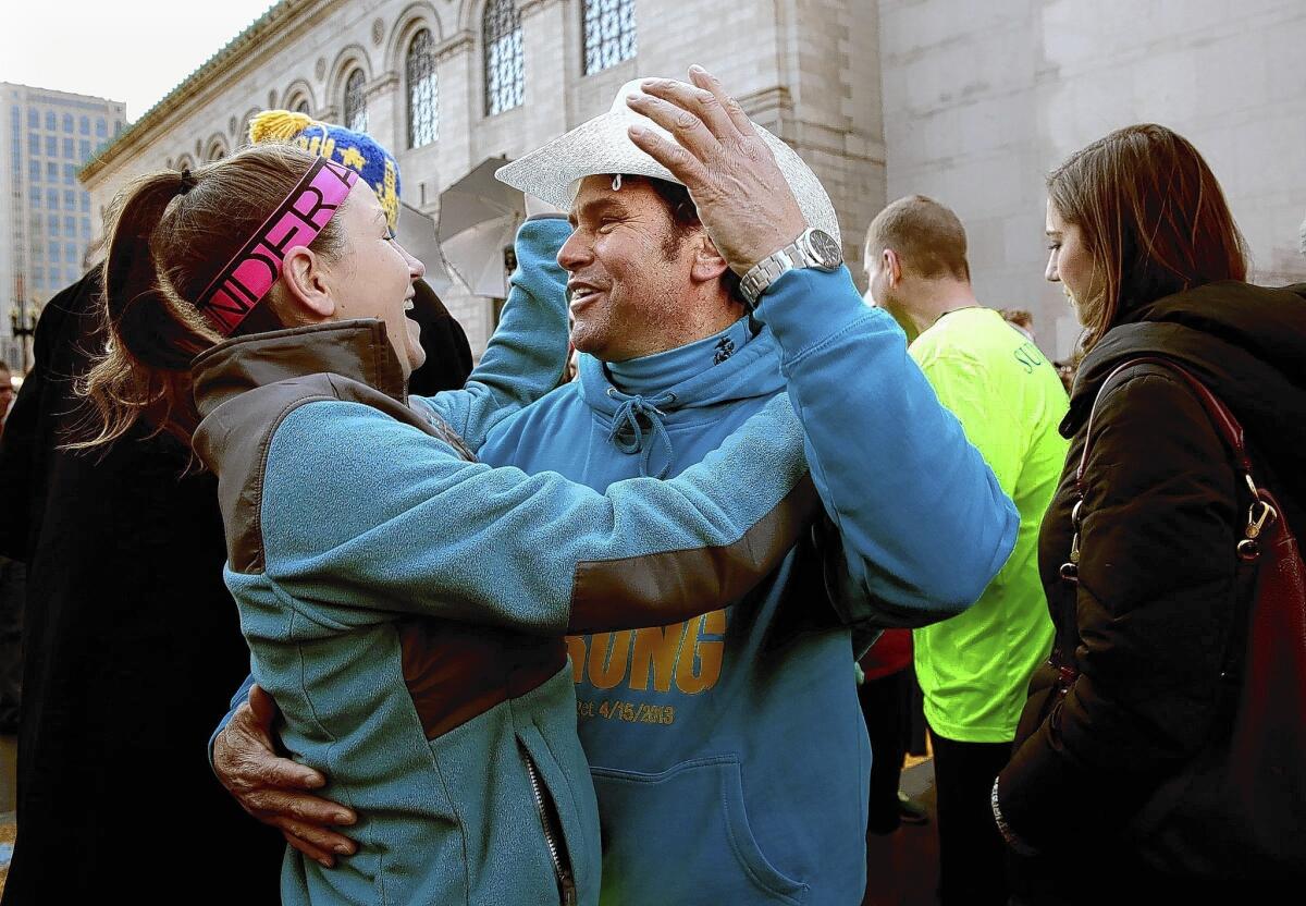 Alexander “Carlos” Arredondo, who aided victims of the Boston Marathon bombing last year, joins a reunion of survivors at the finish line on Boylston Street on April 6.