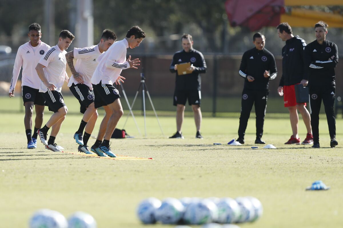 Inter Miami CF head coach Diego Alonso, right, watches players participate in drills during a team practice session in January.