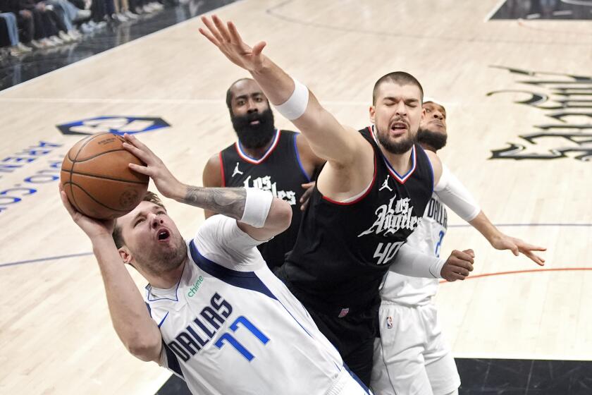 Dallas Mavericks guard Luka Doncic, left, shoots as Los Angeles Clippers guard James Harden, second from left, and center Ivica Zubac second from right, defend while center Daniel Gafford stands behind during the first half in Game 2 of an NBA basketball first-round playoff series Tuesday, April 23, 2024, in Los Angeles. (AP Photo/Mark J. Terrill)