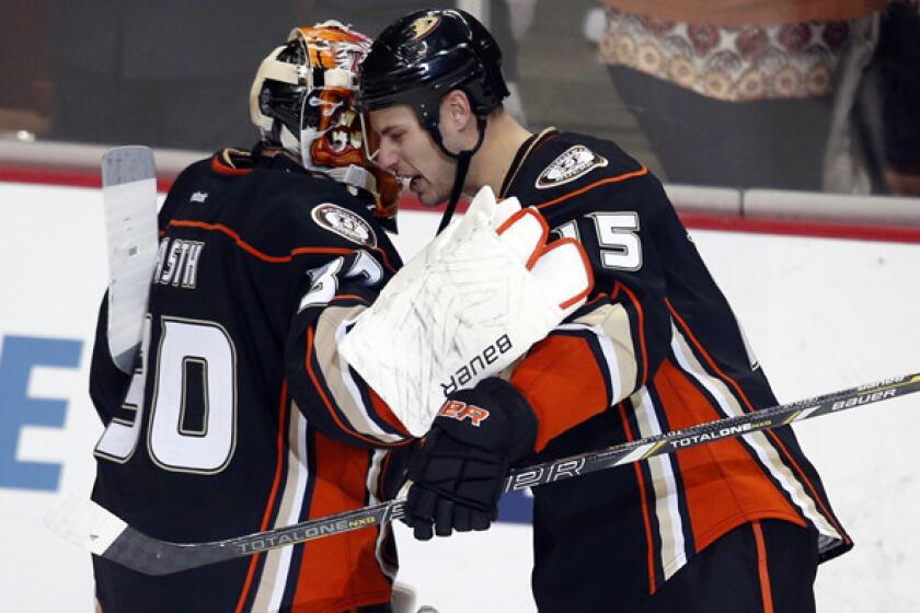 Captain Ryan Getzlaf (15) congratulates goaltender Viktor Fasth after the Ducks defeated the Flames, 4-0, on Friday night.