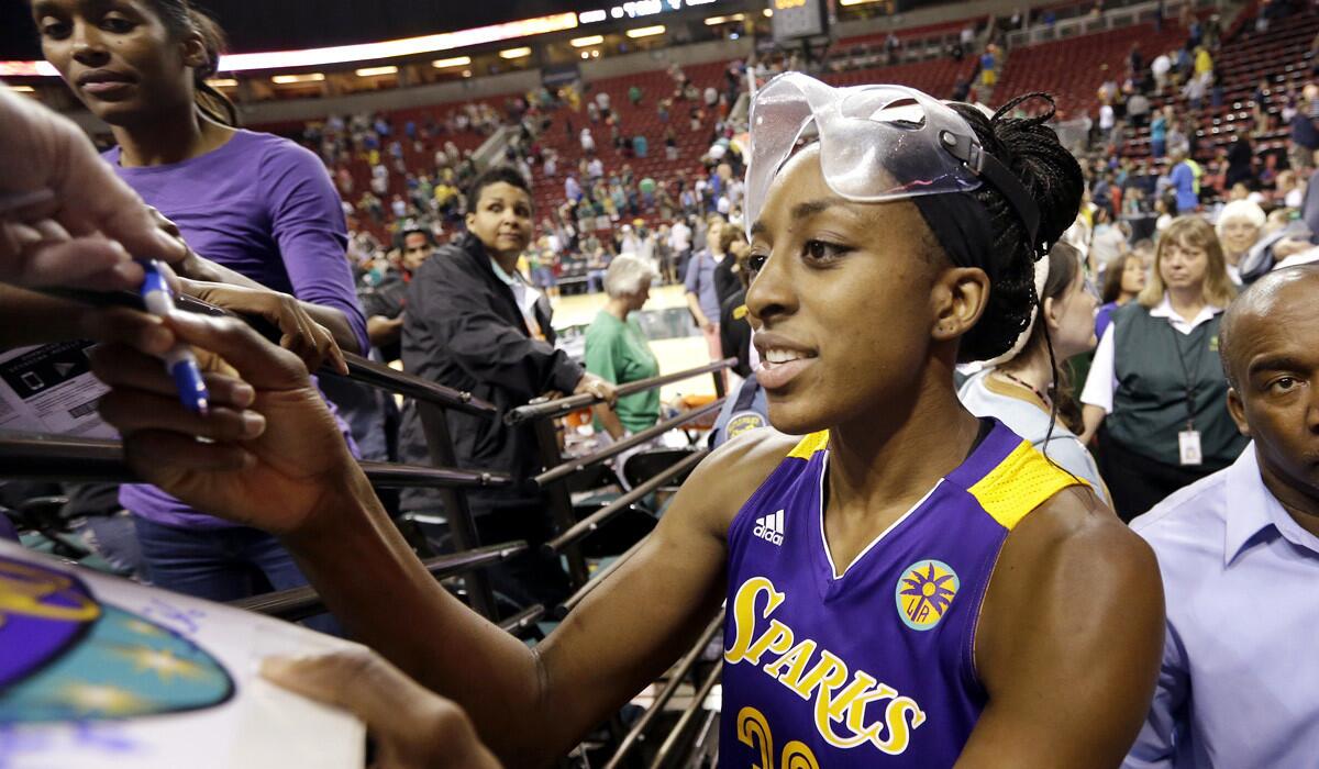Sparks forward Nneka Ogwumike signs an autograph after a 70-56 victory over the Storm last week in Seattle.