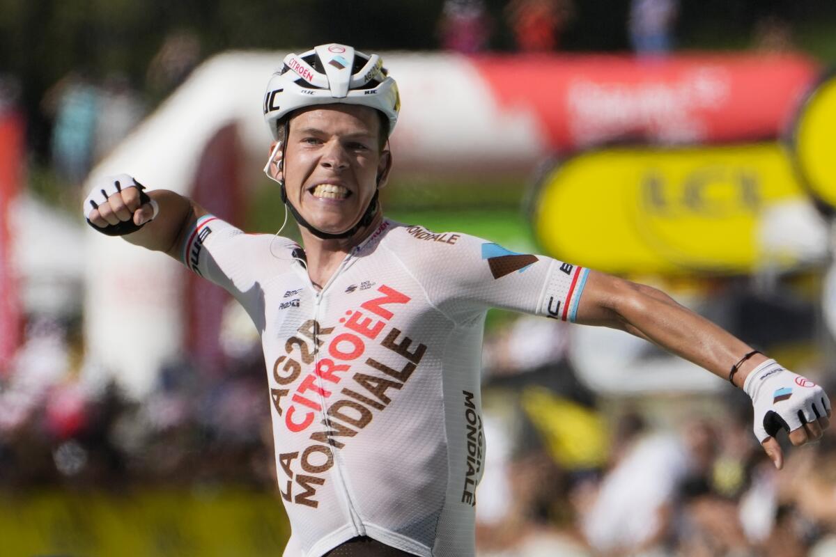 Stage winner Luxembourg's Bob Jungels celebrates as he crosses the finish line during the ninth stage of the Tour de France cycling race over 193 kilometers (119.9 miles) with start in Aigle, Switzerland and finish in Chatel les Portes du Soleil, France, Sunday, July 10, 2022. (AP Photo/Thibault Camus)