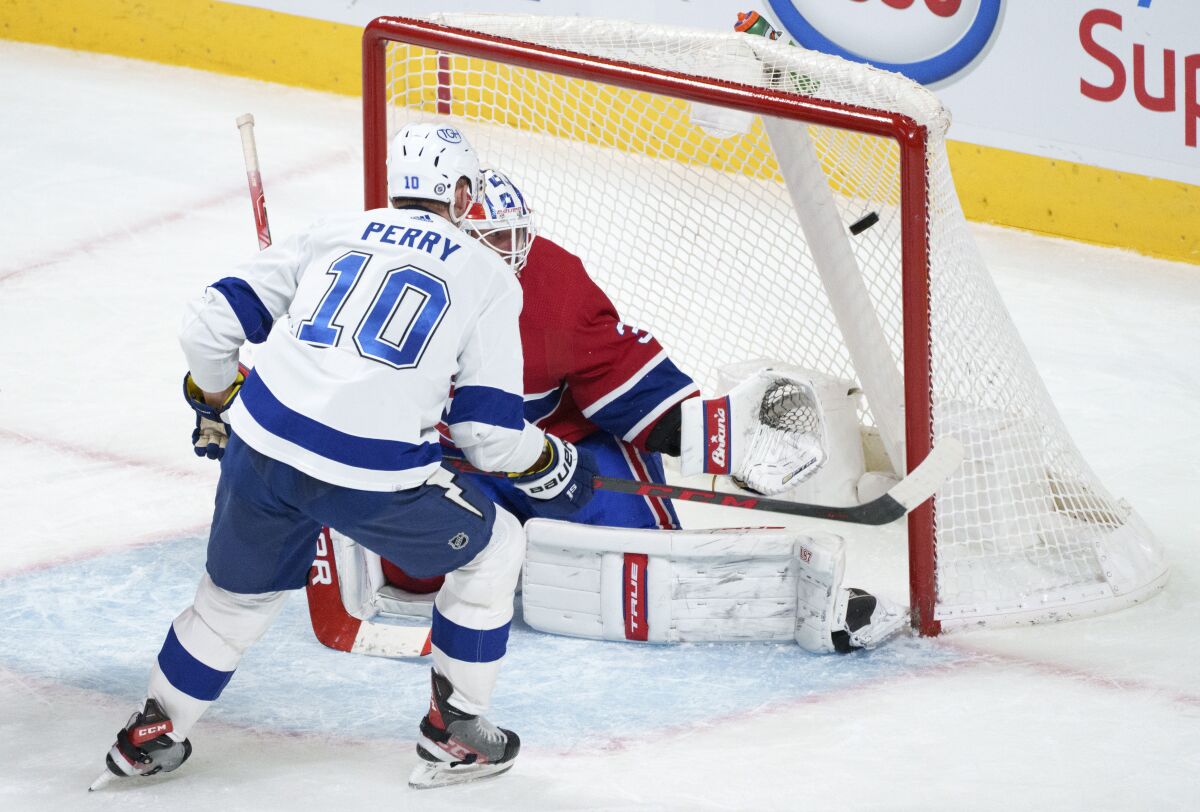 Tampa Bay Lightning's Corey Perry scores past Montreal Canadiens goaltender Jake Allen during the third period of an NHL hockey game Tuesday, Dec. 7, 2021, in Montreal. (Paul Chiasson/The Canadian Press via AP)