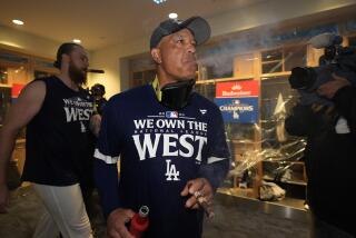 Los Angeles Dodgers manager Dave Roberts celebrates with others after the Dodgers defeated the San Diego Padres 7-2 in a baseball game to clinch the National League West division Thursday, Sept. 26, 2024, in Los Angeles. (AP Photo/Ashley Landis)