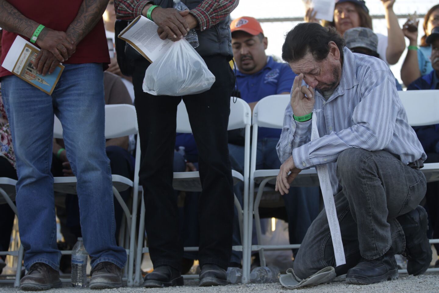 Bert Dunn of El Paso, Texas, prays on the U.S. side of the border with Mexico near Ciudad Juarez, Mexico, on Wednesday as Pope Francis celebrates Mass.