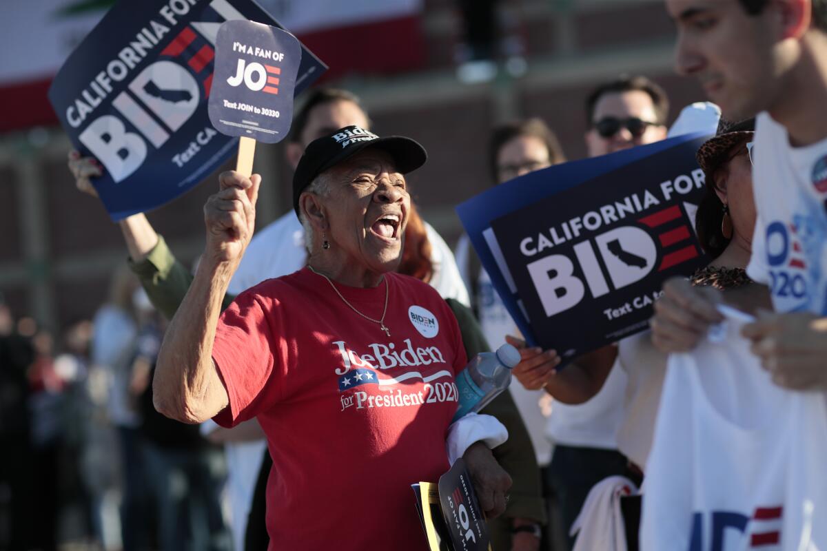 In line for a rally at the Baldwin Hills Recreation Center, Ramona Tolliver joins elated supporters of Democratic presidential hopeful Joe Biden after news broke that he won the North Carolina and Virginia primaries on Super Tuesday.