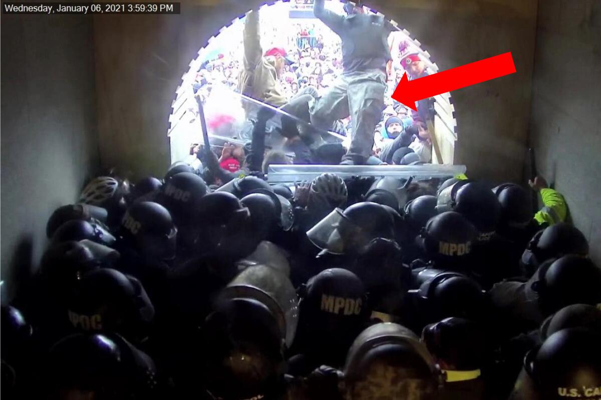 A screengrab from video has a red arrow pointing to David Nicholas Dempsey among a crowd of rioters