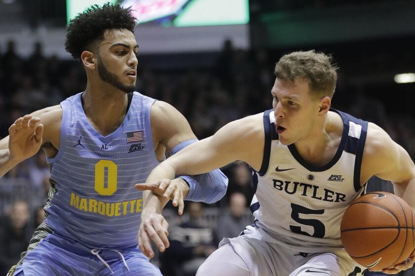 Butler's Paul Jorgensen (5) is defended by Marquette's Markus Howard (0) during the first half of an NCAA college basketball game, Wednesday, Jan. 30, 2019, in Indianapolis. (AP Photo/Darron Cummings)