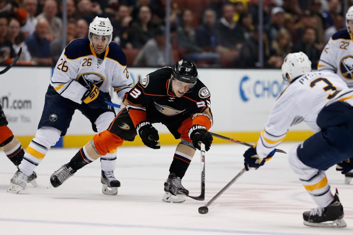 Ducks forward Jakob Silfverberg lunges for a loose puck between Sabres defenseman Mark Pysyk and forward Matt Moulson during a game on Feb. 24.