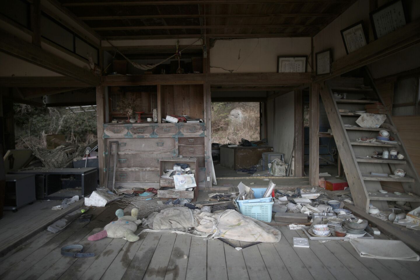 Personal items are strewn around a tsunami-damaged home Minamisoma. The nuclear disaster forced the evacuation of 99,750 people.
