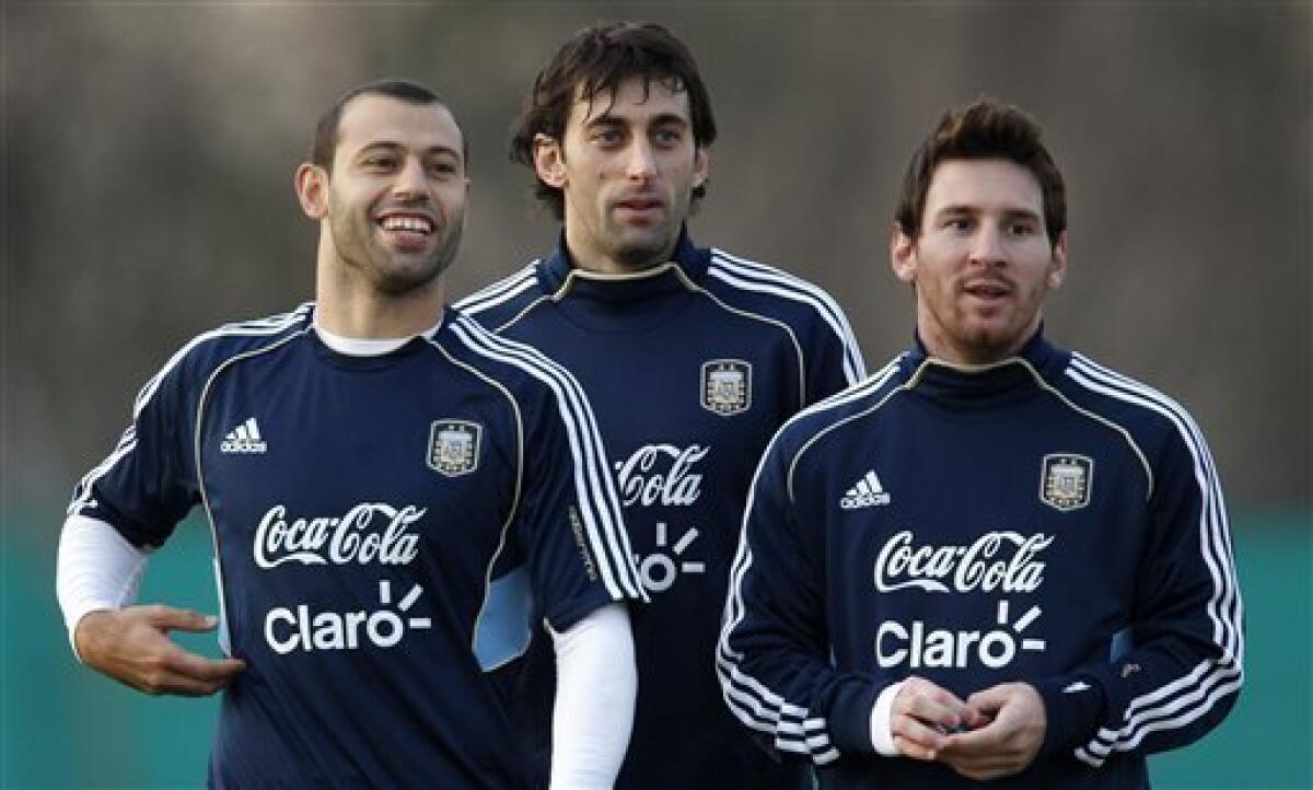Argentina's Lionel Messi, Diego Milito, and Javier Mascherano, right to left, gesture at the end of a training session ahead of the upcoming 2011 Copa America in Buenos Aires, Argentina, Wednesday, June 29, 2011. Argentina will host the Copa America soccer tournament July 1-24.(AP Photo/Natacha Pisarenko)