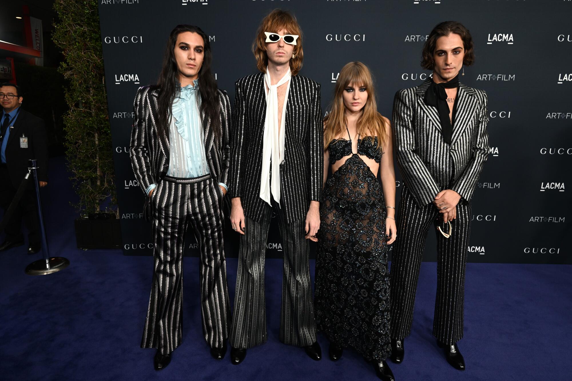 Ethan Torchio, Thomas Raggi, Victoria De Angelis and Damiano David of Maneskin wear black outfits.