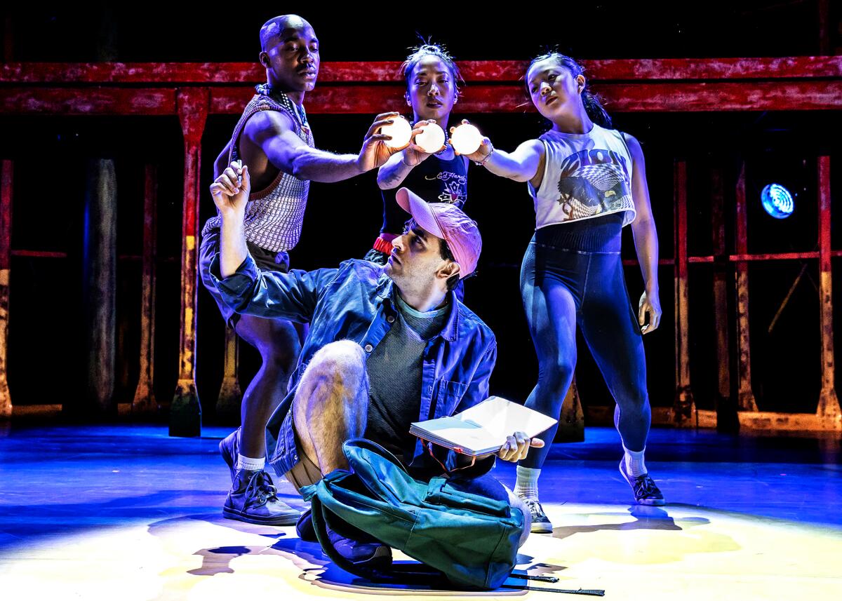 A kneeling Ricky Ubeda is surrounded by, from left, Bryon Tittle, Christina Flores and Kara Chan in "Illinoise."