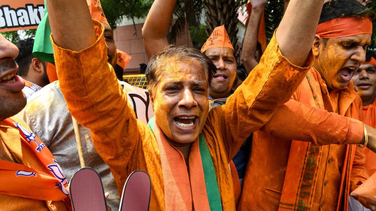 Supporters of Prime Minister Narendra Modi's party celebrate the results of India's election Thursday in New Delhi.