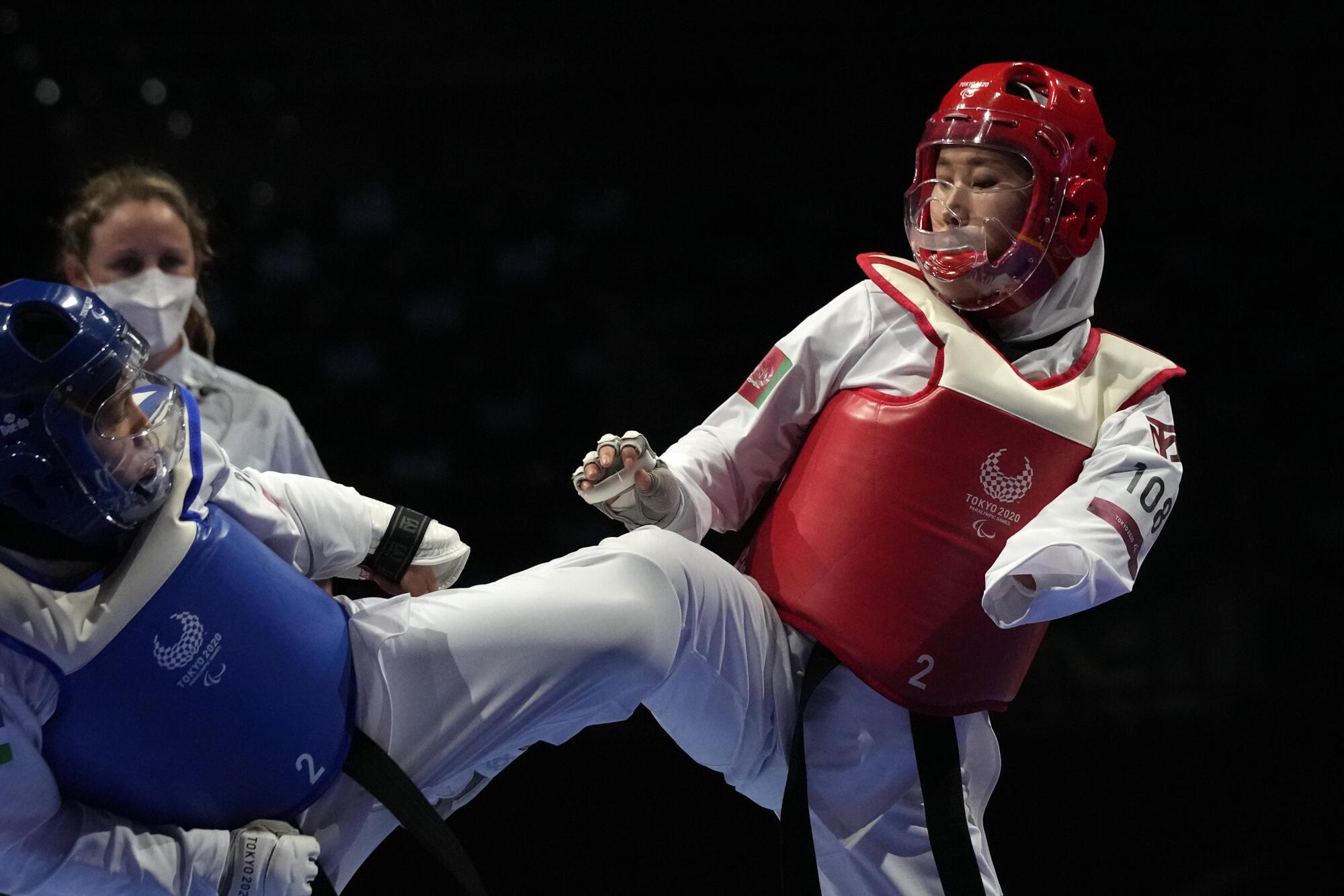 Afghanistan's Zakia Khudadadi competes against Ziyodakhon Isakova of Uzbekistan during their taekwondo match.