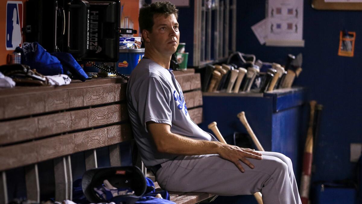 Dodgers starter Rich Hill sits alone in the dugout after he was replaced after pitching seven perfect innings.