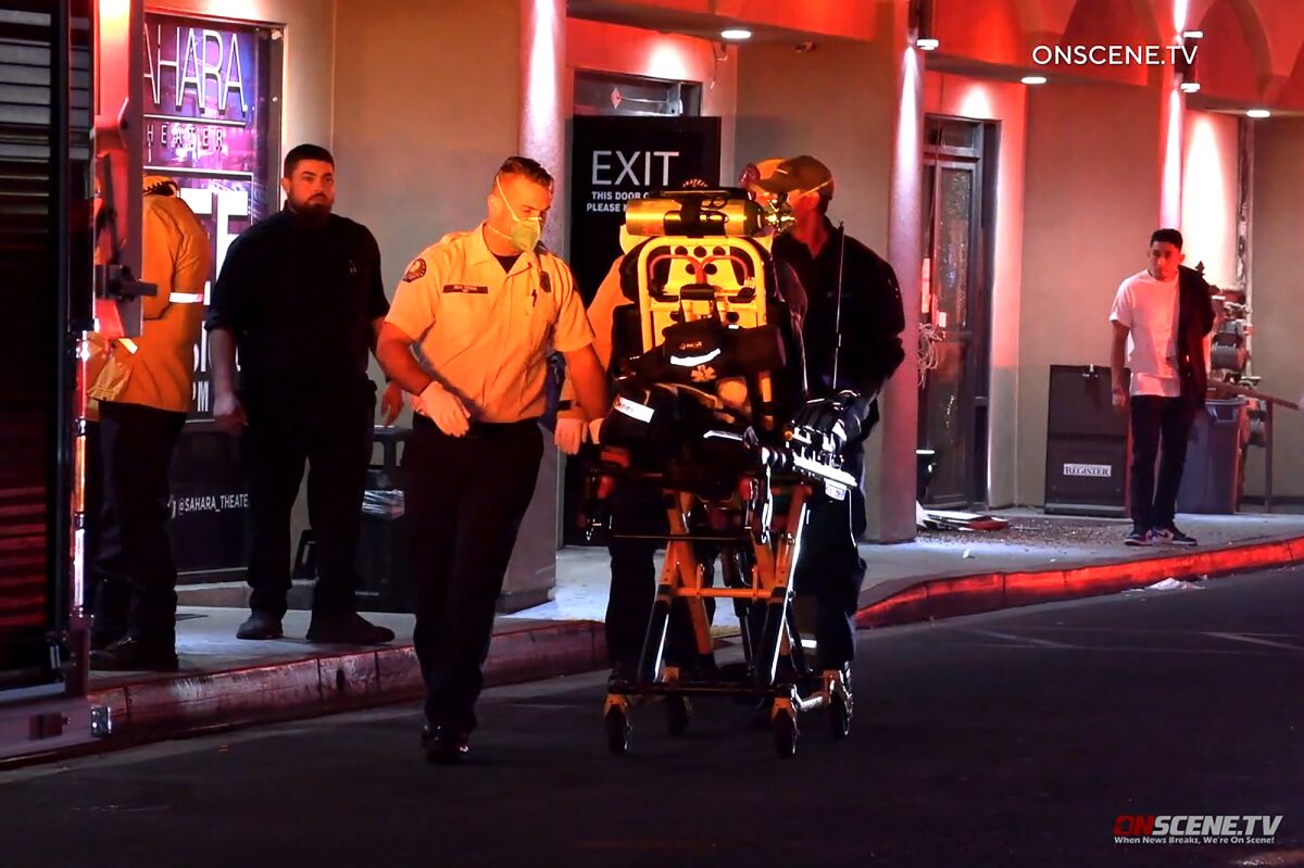 An injured person is wheeled to an ambulance after a shooting at the Sahara Theater club in Anaheim.